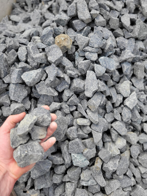 Close up of crushed black granite angular decorative gravel used for landscape beds located in Kansas City.