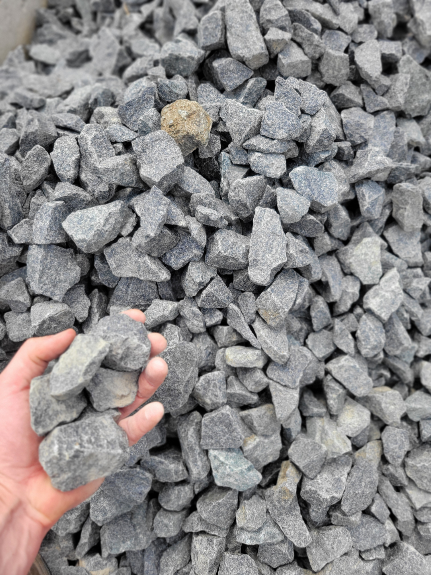 Close up of crushed black granite angular decorative gravel used for landscape beds located in Kansas City.