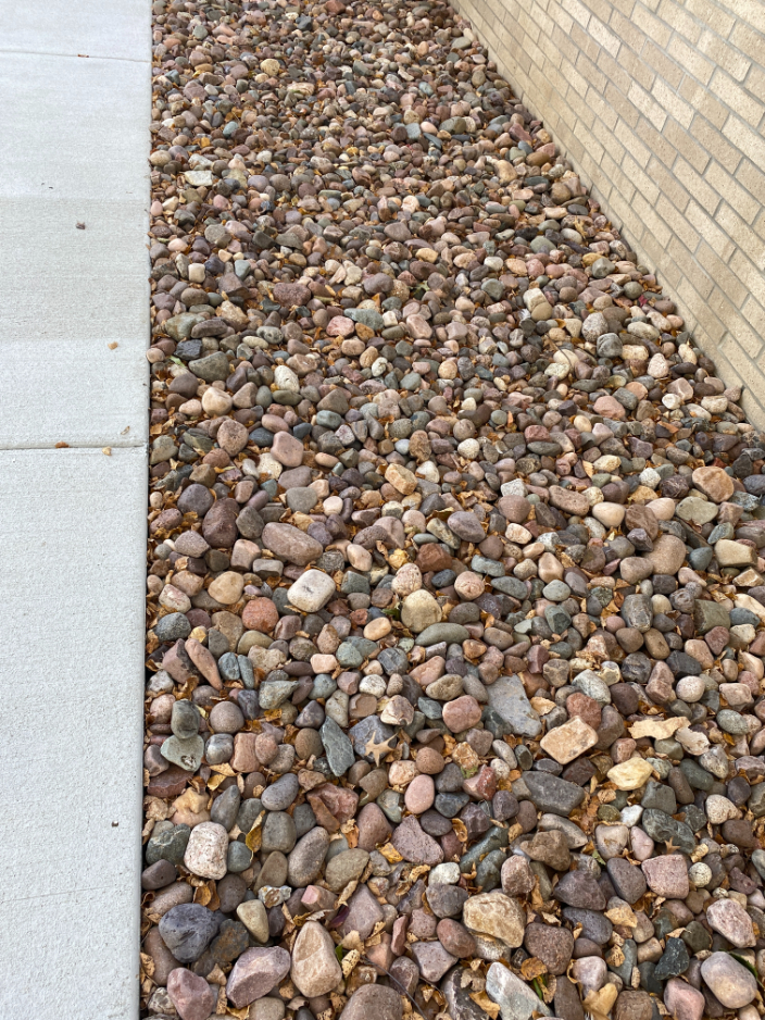Eau Claire river rock in a landscape bed located in Kansas City