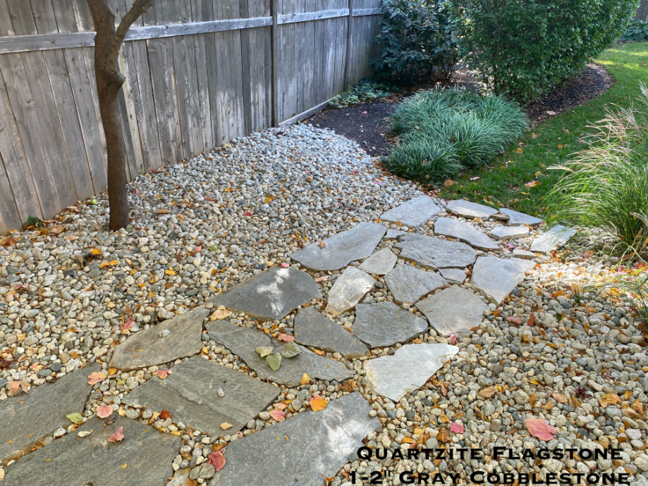 Gray cobblestone used with flagstone in a landscape located in Kansas City