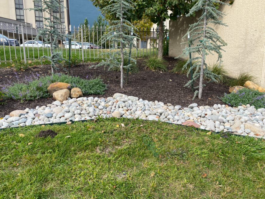 Gray Cobblestone next to a landscape bed with trees in Kansas City