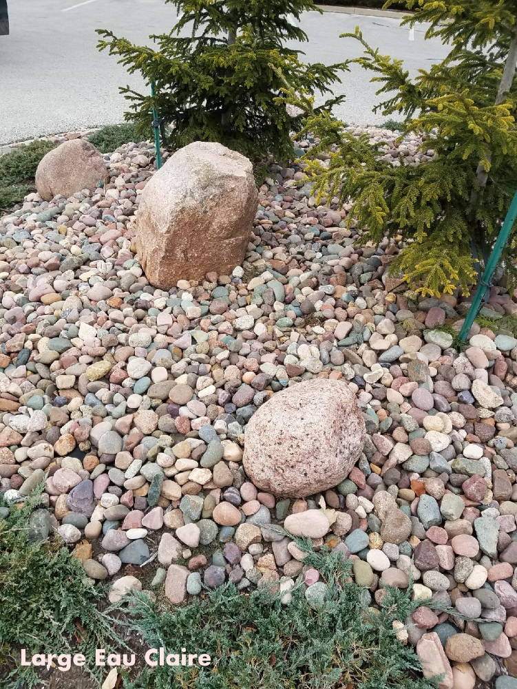 Eau Claire river rock mixed with small boulders in a landscape bed located in Kansas City