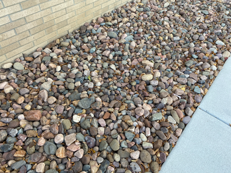 Eau Claire river rock in a landscape bed located in Kansas City
