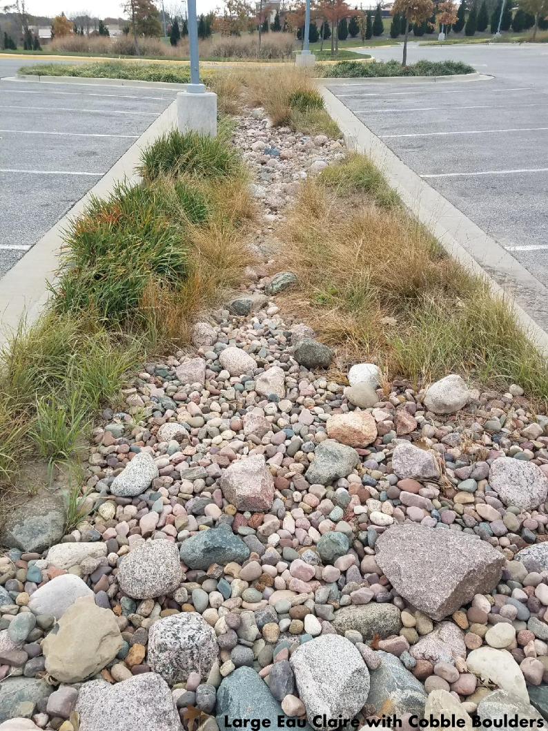 Eau Claire river rock mixed with small boulders in a landscape bed located in Kansas City