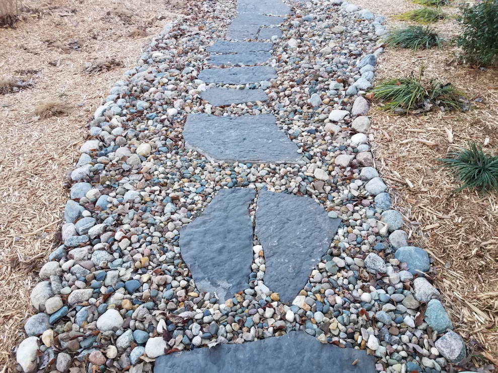 Missouri Rainbow River Rock used in a landscape bed located in Kansas City
