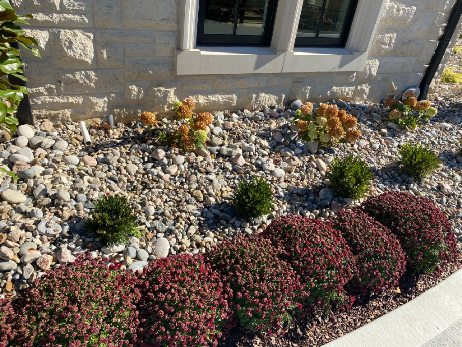 Missouri Rainbow River Rock used in a landscape bed located in Kansas City