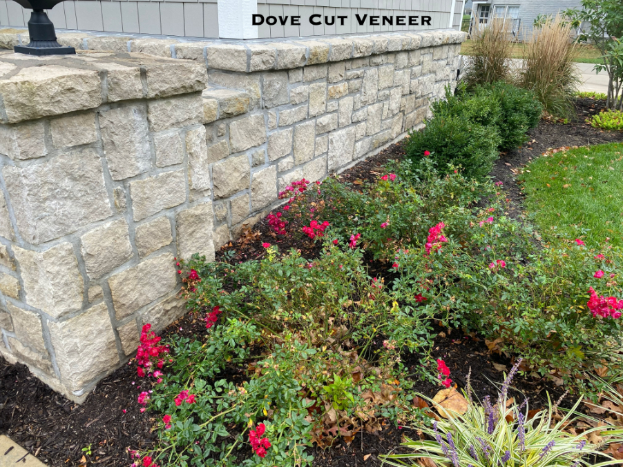 Close up photo of Dove Gray Random Ashlar Veneer as a wainscot with a hammered stone sill
